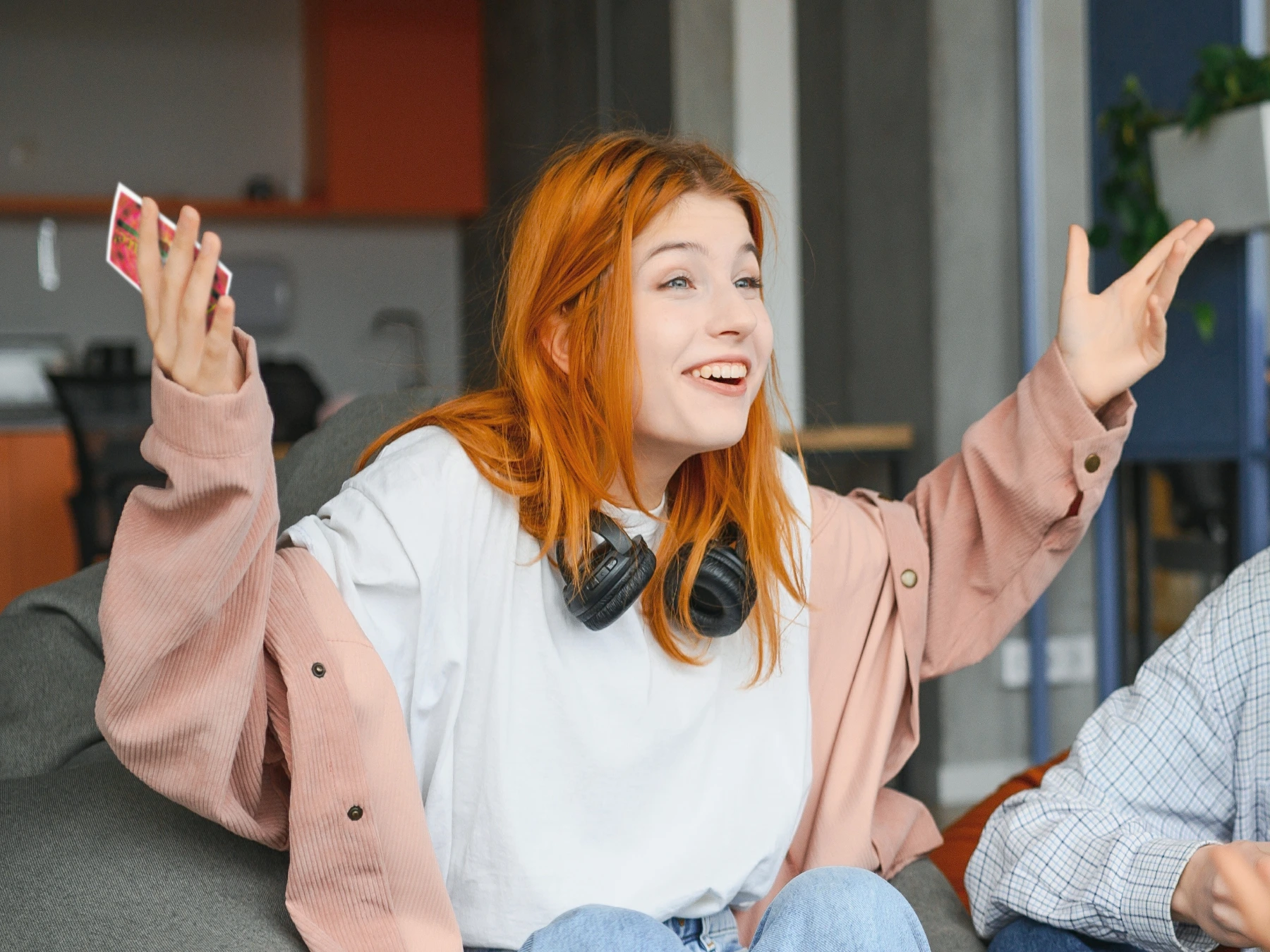 Young woman shrugging while playing Articulate